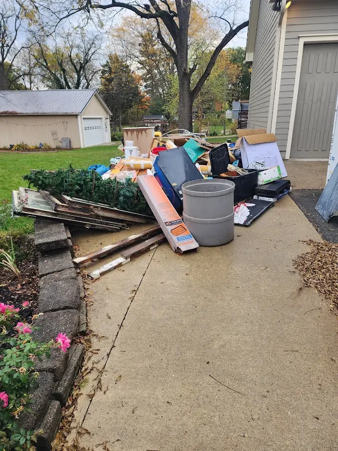 Dumpster being loaded with debris for Roofing Dumpster Rental in McKinleyville